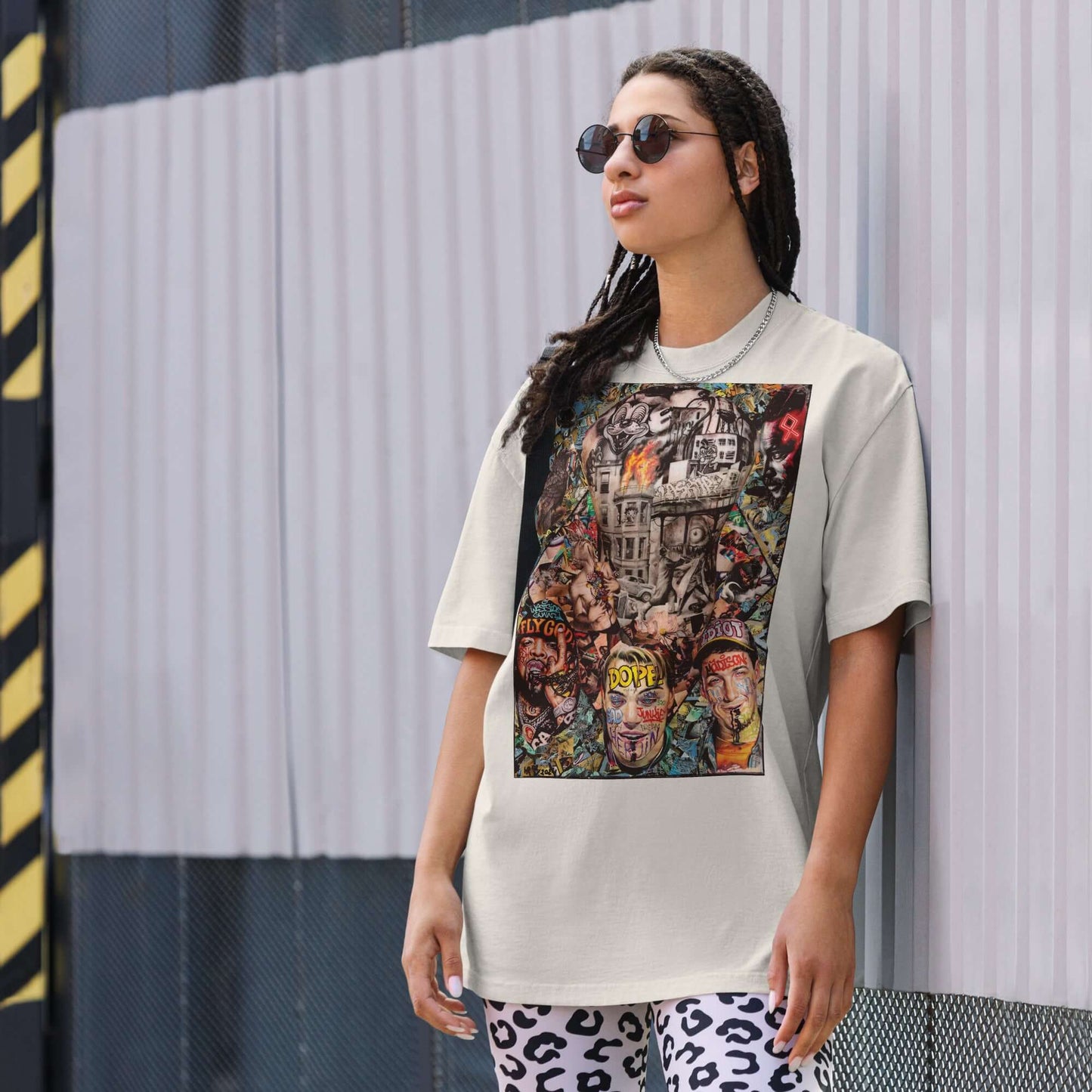 Model wearing 'DOPE' oversized t-shirt with vibrant urban art collage design, reflecting contemporary street culture.